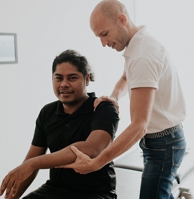 Osteopath trating a patient about carpal canal syndrome, checking on your whole body in order to improve its general