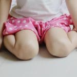 A girl in w-sitting position